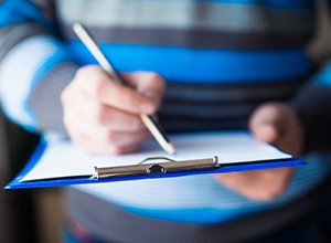 Man filling out a dental insurance form