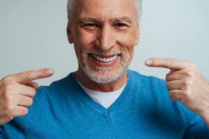 Senior man smiling with dentures. 